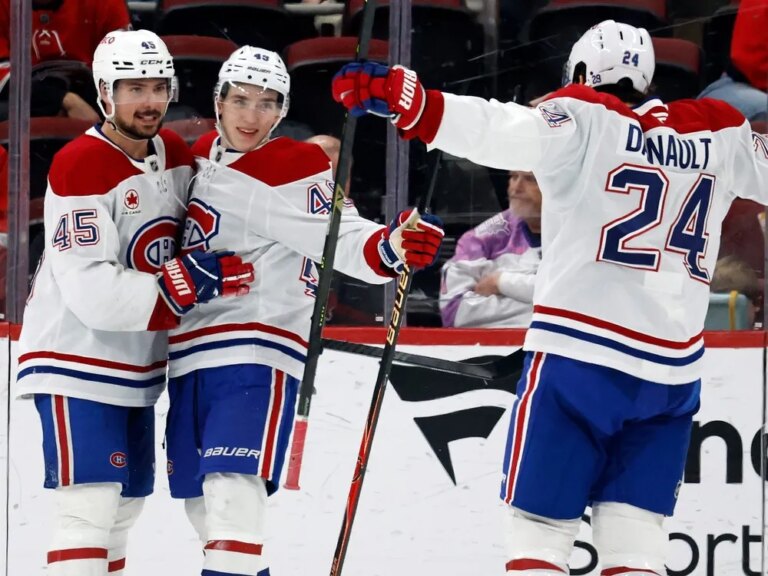 Canadiens defenceman Lane Hutson, centre, celebrates his empty-net goal with Alexandre Carrier and Phillip Danault on Thursday against the Carolina Hurricanes as the Habs improved to 12-3-5 through their first 20 road games of the season.