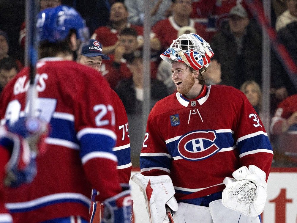 Canadiens goaltender Jacob Fowler (32) laughs with goaltender Jakub Dobes (75) after beating the Calgary Flames 4-1 in Montreal, on Wednesday, Jan. 7, 2026.