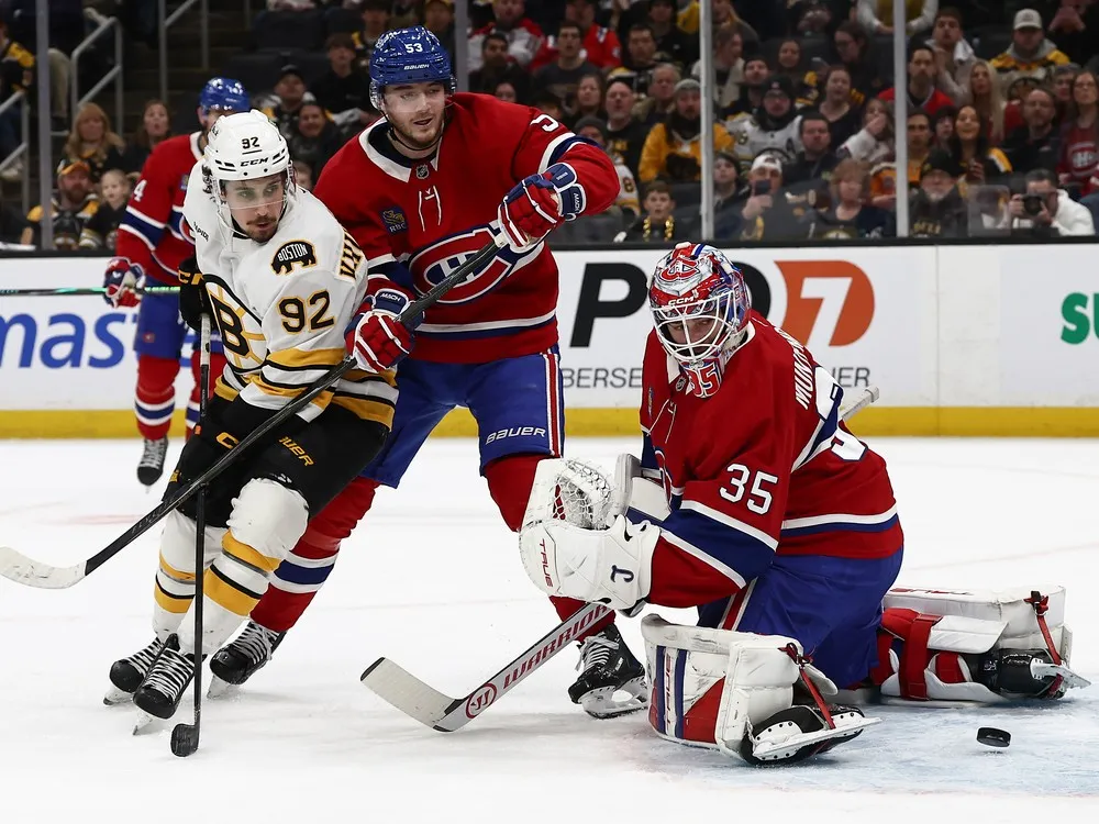 Canadiens goaltender Samuel Montembeault looks back to see the puck come back after hitting the post as Bruins' Marat Khusnutdinov (92) looks for the rebound during the first period at TD Garden on Saturday, Jan. 24, 2026, in Boston.