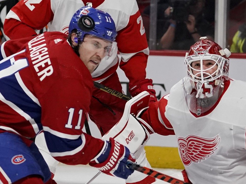 Canadiens winger Brendan Gallagher battles for position as the puck whistles past his head toward Detroit Red Wings goaltender Jonathan Bernier in Montreal on Dec. 14, 2019.