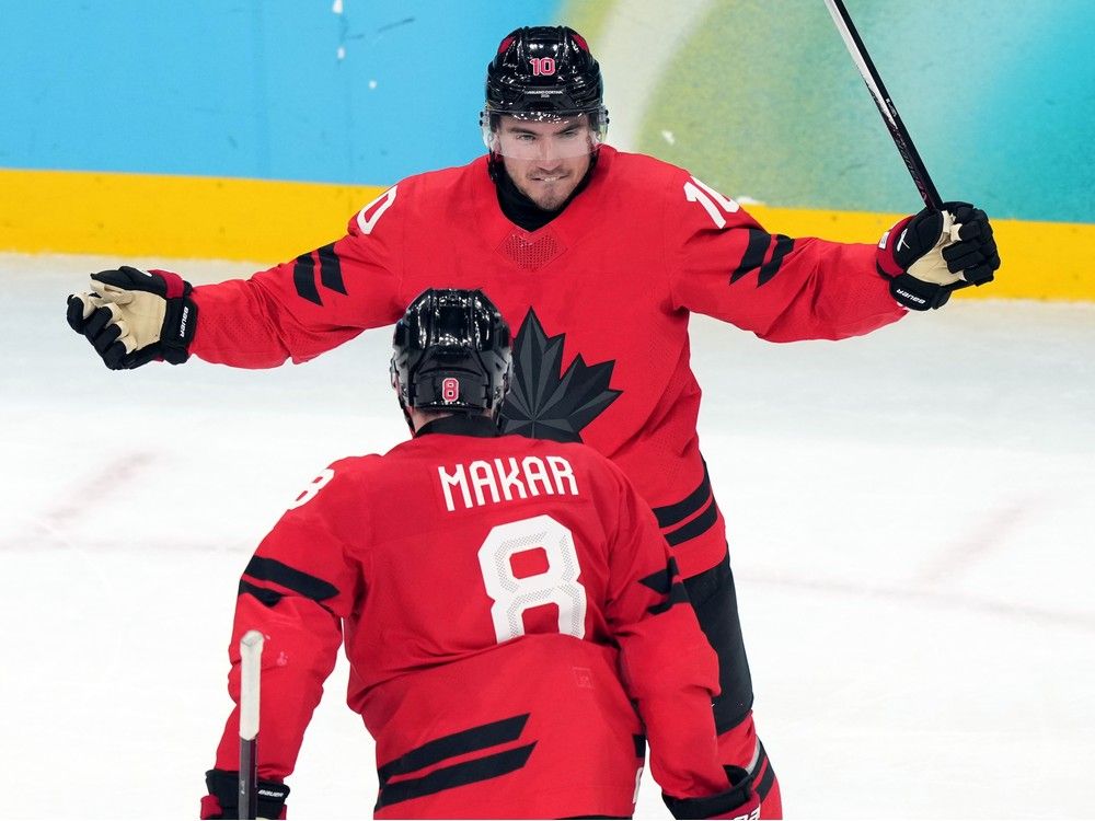 Canada's Nick Suzuki celebrates with Cale Makar after Suzuki scored the tying goal against Czechia late in the third period of a quarterfinal in Milan at the Winter Olympics.