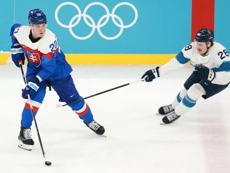Finland's Eeli Tolvanen pursues Slovakia's Juraj Slafkovsky during Olympic bronze-medal game Saturday in Milan, Italy.