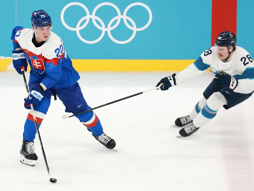 Finland's Eeli Tolvanen pursues Slovakia's Juraj Slafkovsky during Olympic bronze-medal game Saturday in Milan, Italy.