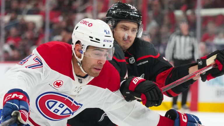Jan 1, 2026; Raleigh, North Carolina, USA;  Carolina Hurricanes center Sebastian Aho (20) and Montréal Canadiens defenseman Jayden Struble (47) battle for position during the third period at Lenovo Center. Mandatory Credit: James Guillory-Imagn Images