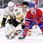 Jan 24, 2026; Boston, Massachusetts, USA; Boston Bruins defenseman Charlie McAvoy (73) and Montreal Canadiens right wing Cole Caufield (13) battle for the puck during the second period at TD Garden. Mandatory Credit: Bob DeChiara-Imagn Images