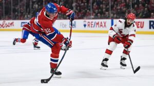 Feb 25, 2025; Montreal, Quebec, CAN; Montreal Canadiens right wing Patrik Laine (92) shoots the puck against the Carolina Hurricanes in the third period at Bell Centre. Mandatory Credit: David Kirouac-Imagn Images