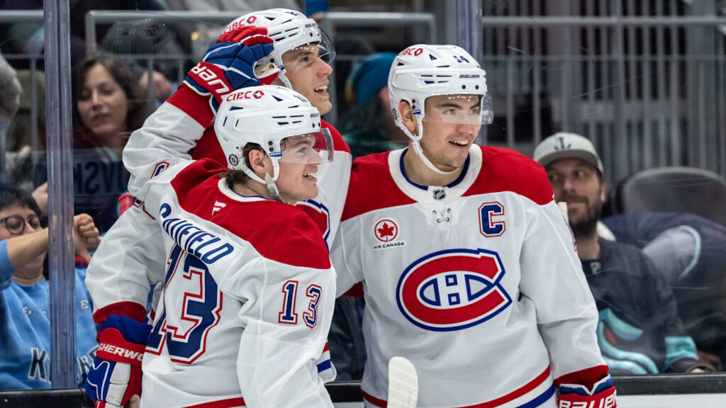Mar 12, 2025; Seattle, Washington, USA;  Montreal Canadiens forward Cole Caufield (13) forward Juraj Slafkovský (20) and forward Nick Suzuki (14) celebrate a goal during the second period against the Seattle Kraken at Climate Pledge Arena. Mandatory Credit: Stephen Brashear-Imagn Images