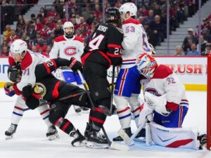 Canadiens forward Jake Evans removes Senators' Fabian Zetterlund from net front as Habs' Noah Dobson and Sens' Dylan Cozens scrum in front of goalie Jacob Fowler during second period in Ottawa on Wednesday.