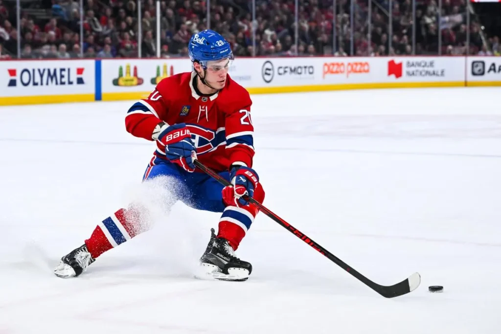 Montreal Canadiens left wing Juraj Slafkovsky (20) plays the puck against the New York Islanders during overtime at Bell Centre.