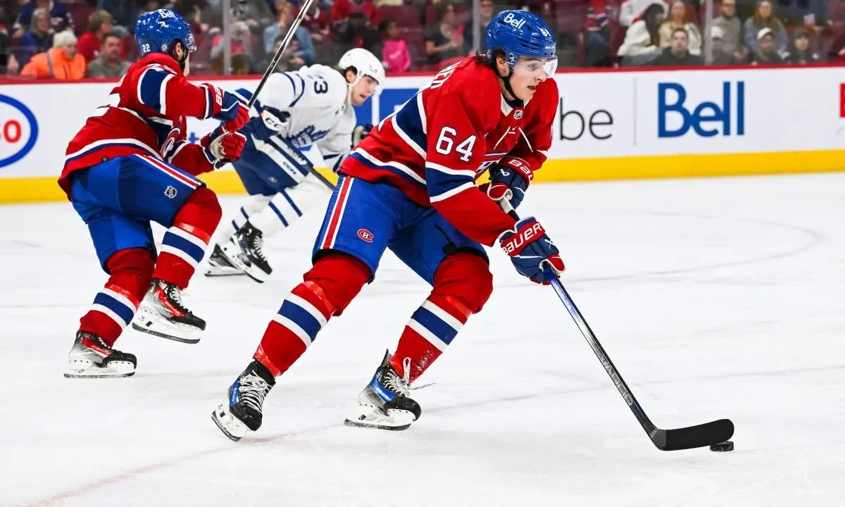Montreal Canadiens defenseman David Reinbacher (64) plays the puck against the Toronto Maple Leafs during the third period at Bell Centre.