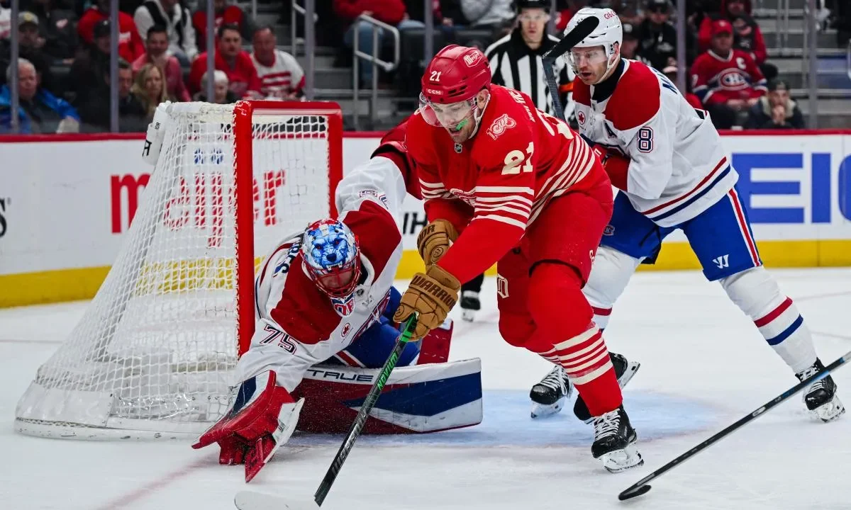 Montreal Canadiens goaltender Jakub Dobes (75) and defenseman Mike Matheson (8) defend the net against Detroit Red Wings left wing James van Riemsdyk (21) during the second period at Little Caesars Arena.