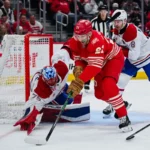 Montreal Canadiens goaltender Jakub Dobes (75) and defenseman Mike Matheson (8) defend the net against Detroit Red Wings left wing James van Riemsdyk (21) during the second period at Little Caesars Arena.