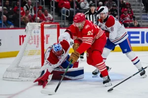 Montreal Canadiens goaltender Jakub Dobes (75) and defenseman Mike Matheson (8) defend the net against Detroit Red Wings left wing James van Riemsdyk (21) during the second period at Little Caesars Arena.