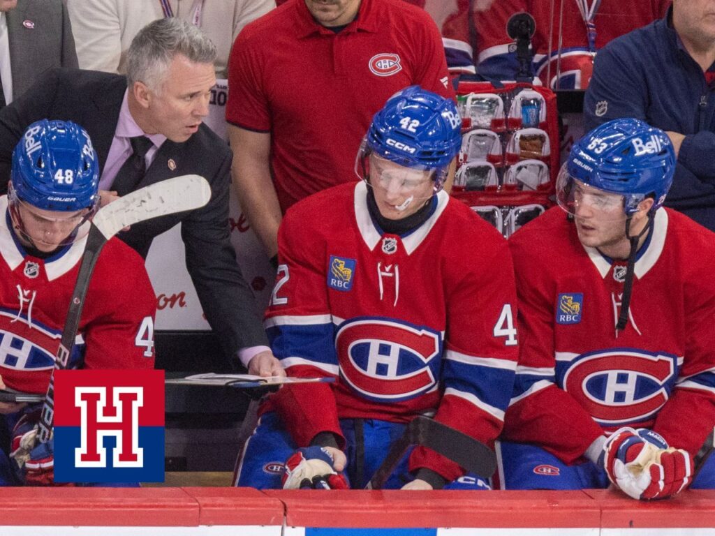 Canadiens head coach Martin St. Louis gives instructions to Adam Engstrom and Noah Dobson, far right, as fellow defenceman Lane Hutson consults a tablet during third period against the Philadelphia Flyers in Montreal on Dec. 16, 2025.
