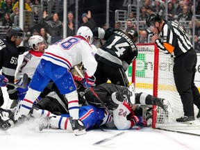 Players pile on in from of the goal during the third period of an NHL hockey game between the Los Angeles Kings and the Montréal Canadiens.