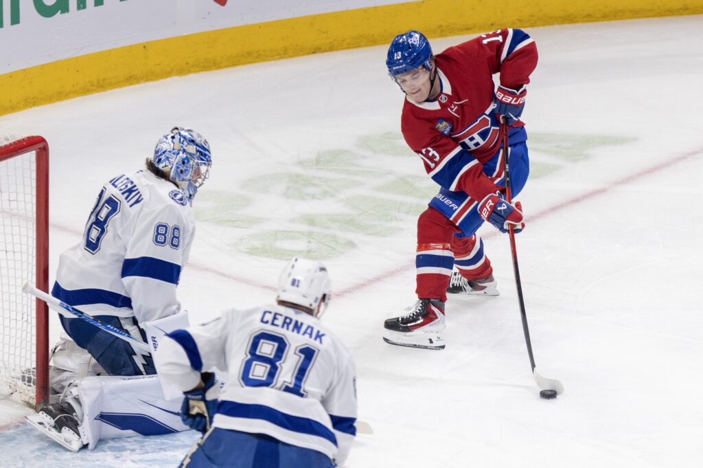 Canadiens winger Cole Caufield takes a shot on Tampa Bay Lightning goalie Andrei Vasilevskiy as defenceman Erik Cernak watches during first period in Montreal on April 9.