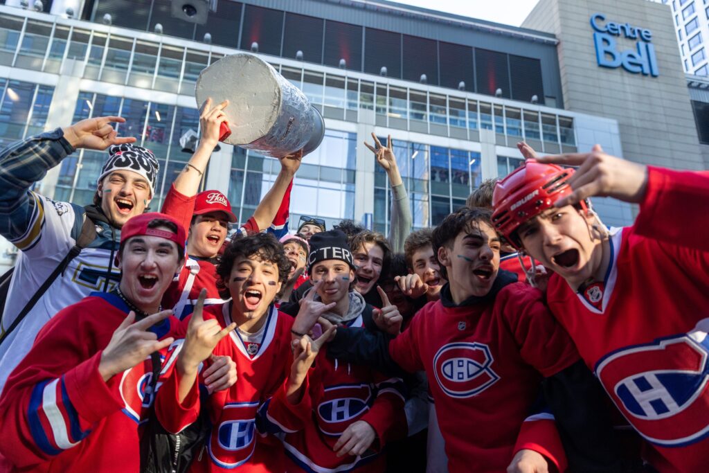 Canadiens fans throng outside the Bell Centre before Game 3, one holding aloft a replica Stanley Cup.