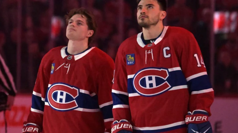 Montreal Canadiens forward Cole Caufield (13) and teammate forward Nick Suzuki (14) during the National Anthem before the game against the Florida Panthers at the Bell Centre.