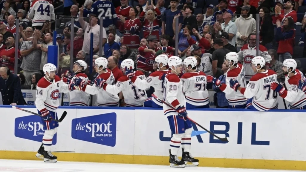 Montreal Canadian left wing Juraj Slafkovsky (20) celebrates with his teammates after scoring a goal in the first period against the Tampa Bay Lightning at Benchmark International Arena.
