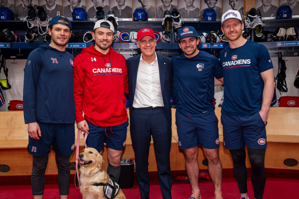Prime Minister Mark Carney, centre, in Canadiens dressing room with, from left, Jake Evans, Nick Suzuki, Alex Newhook and Mike Matheson on Thursday night.