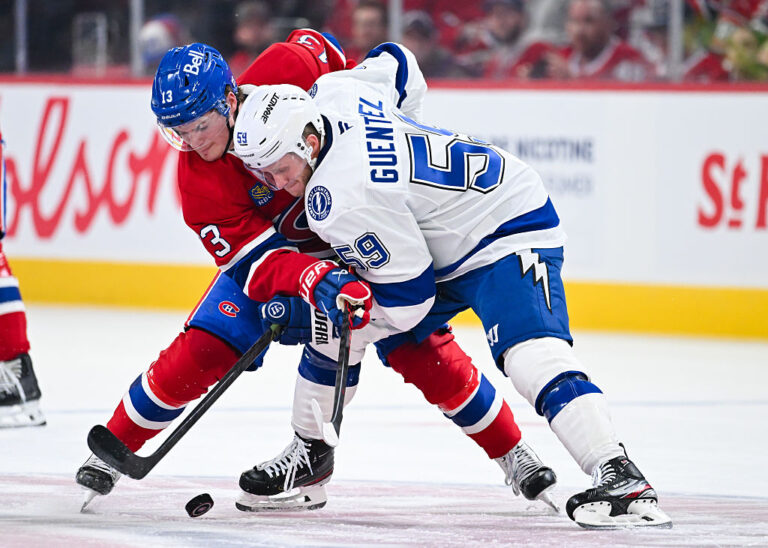 MONTREAL, CANADA - APRIL 24: Cole Caufield #13 of the Montréal Canadiens and Jake Guentzel #59 of the Tampa Bay Lightning battle for the puck in the second period of Game Three of the First Round of the 2026 Stanley Cup Playoffs at the Bell Centre on April 24, 2026 in Montreal, Quebec, Canada. (Photo by Minas Panagiotakis/Getty Images)