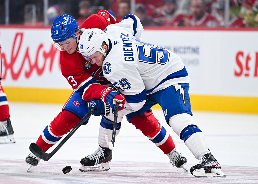 MONTREAL, CANADA - APRIL 24: Cole Caufield #13 of the Montréal Canadiens and Jake Guentzel #59 of the Tampa Bay Lightning battle for the puck in the second period of Game Three of the First Round of the 2026 Stanley Cup Playoffs at the Bell Centre on April 24, 2026 in Montreal, Quebec, Canada. (Photo by Minas Panagiotakis/Getty Images)