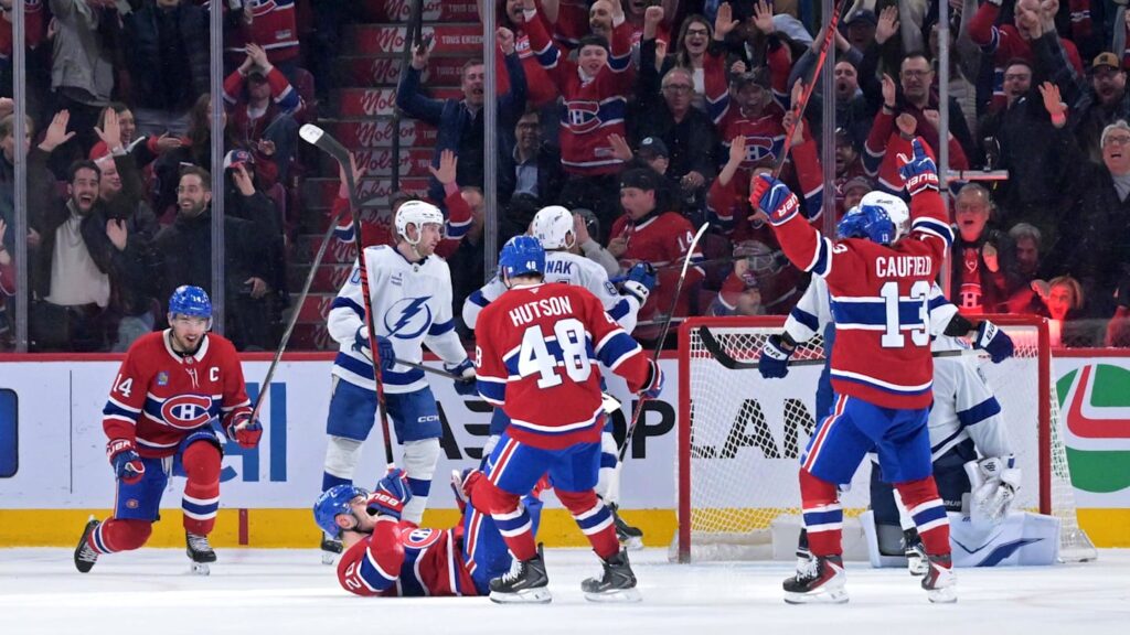 Apr 9, 2026; Montreal, Quebec, CAN; Montreal Canadiens forward Juraj Slafkovsky (20) celebrates with teammates including forward Cole Caufield (13) and forward Nick Suzuki (14) after scoring a goal against the Tampa Bay Lightning during the third period at the Bell Centre. Mandatory Credit: Eric Bolte-Imagn Images