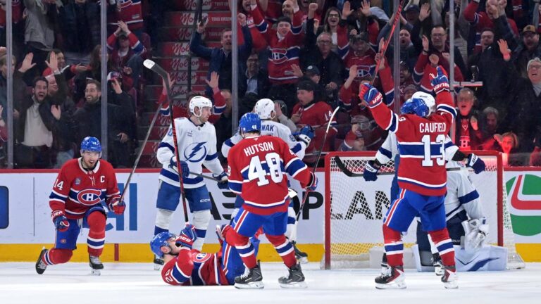 Apr 9, 2026; Montreal, Quebec, CAN; Montreal Canadiens forward Juraj Slafkovsky (20) celebrates with teammates including forward Cole Caufield (13) and forward Nick Suzuki (14) after scoring a goal against the Tampa Bay Lightning during the third period at the Bell Centre. Mandatory Credit: Eric Bolte-Imagn Images