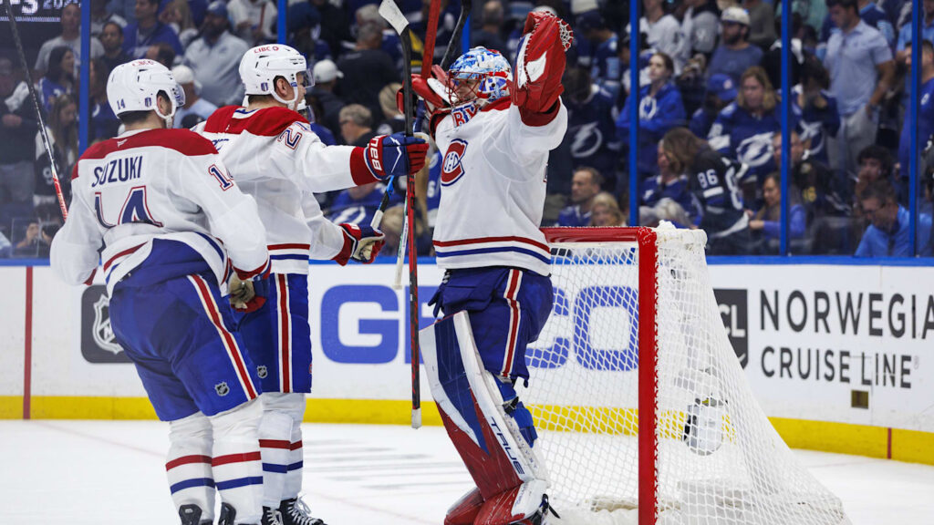 May 3, 2026; Tampa, Florida, USA; Montreal Canadiens goalie Jakub Dobes (75), defenseman Kaiden Guhle (21) and forward Nick Suzuki (14) react to beating the Tampa Bay Lightning in game seven of the first round of the 2026 Stanley Cup Playoffs at Benchmark International Arena. Mandatory Credit: Morgan Tencza-Imagn Images