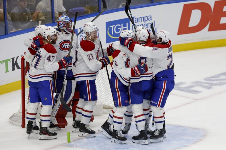 Canadiens players hug one another in groups after winning Game 7.