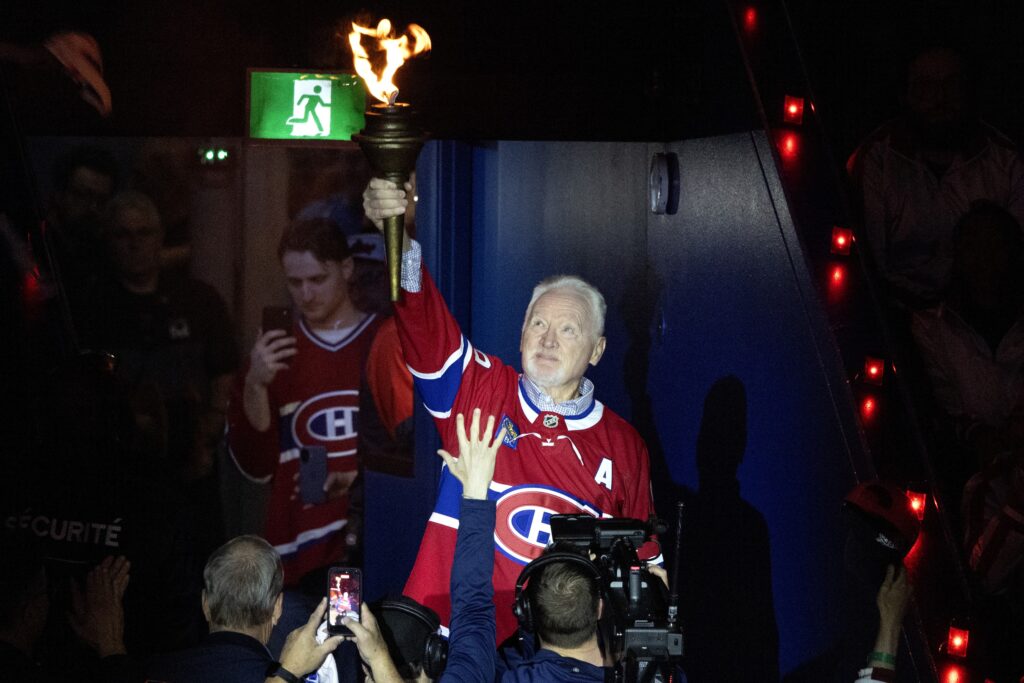 Larry Robinson carries the torch into the Bell Centre during the pregame ceremony of Game 6.