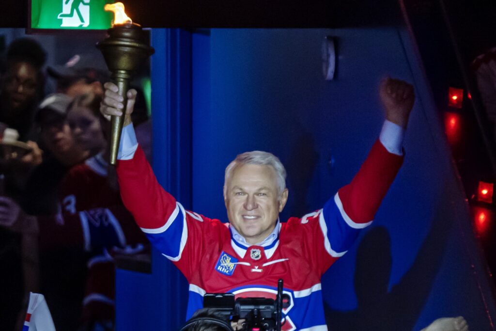 Former Canadien Claude Lemieux carries the torch into the Bell Centre.