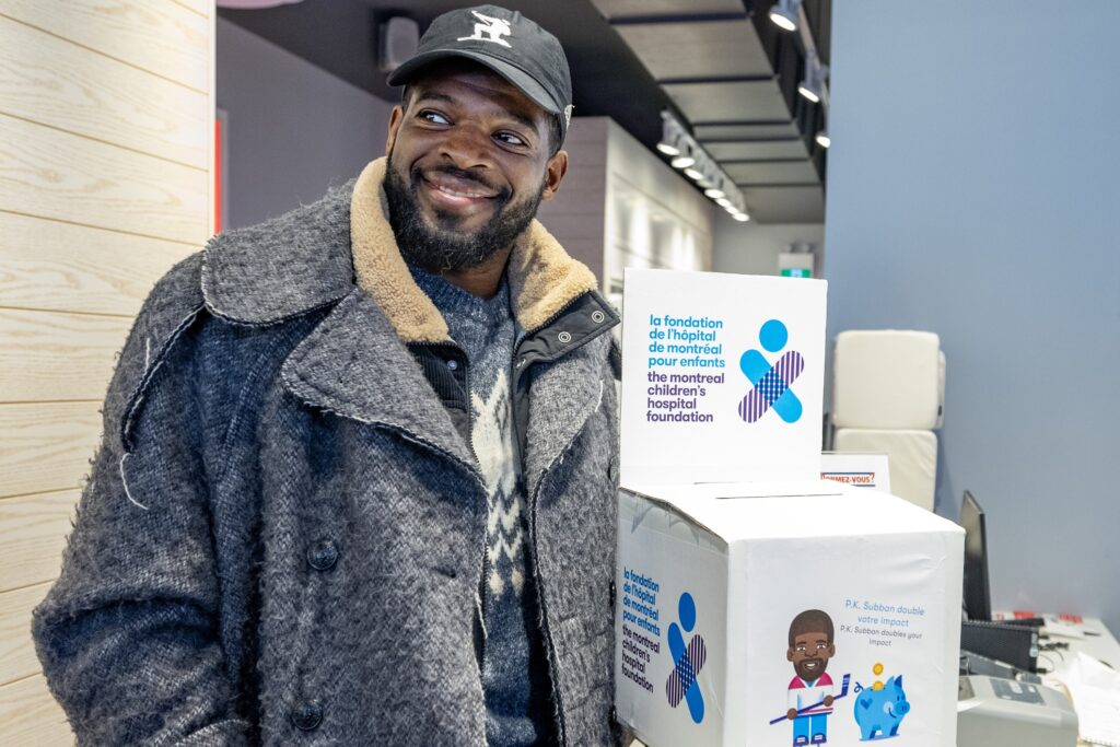 Former Canadiens star P.K. Subban picks up a box of cheques for the Montreal Children