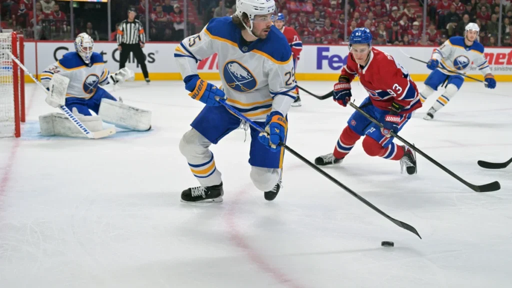 Buffalo Sabres defenseman Owen Power (25) plays the puck and Montreal Canadiens forward Ivan Demidov (93) pressures during the first period in game three of the second round of the 2026 Stanley Cup Playoffs at the Bell Centre.