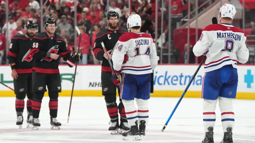 Carolina Hurricanes center Jordan Staal (11) shakes hands with Montreal Canadiens center Nick Suzuki (14) at center ice after game five of the Eastern Conference Final of the 2026 Stanley Cup Playoffs at Lenovo Center.