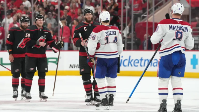 Carolina Hurricanes center Jordan Staal (11) shakes hands with Montreal Canadiens center Nick Suzuki (14) at center ice after game five of the Eastern Conference Final of the 2026 Stanley Cup Playoffs at Lenovo Center.