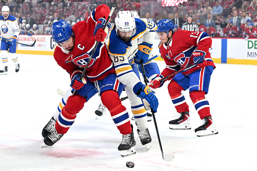 MONTREAL, CANADA - MAY 16: Nick Suzuki #14 of the Montréal Canadiens and Alex Tuch #89 of the Buffalo Sabres battle for the puck during the first period in Game Six of the Second Round of the 2026 Stanley Cup Playoffs at Bell Centre on May 16, 2026 in Montreal, Quebec, Canada. (Photo by Minas Panagiotakis/Getty Images)