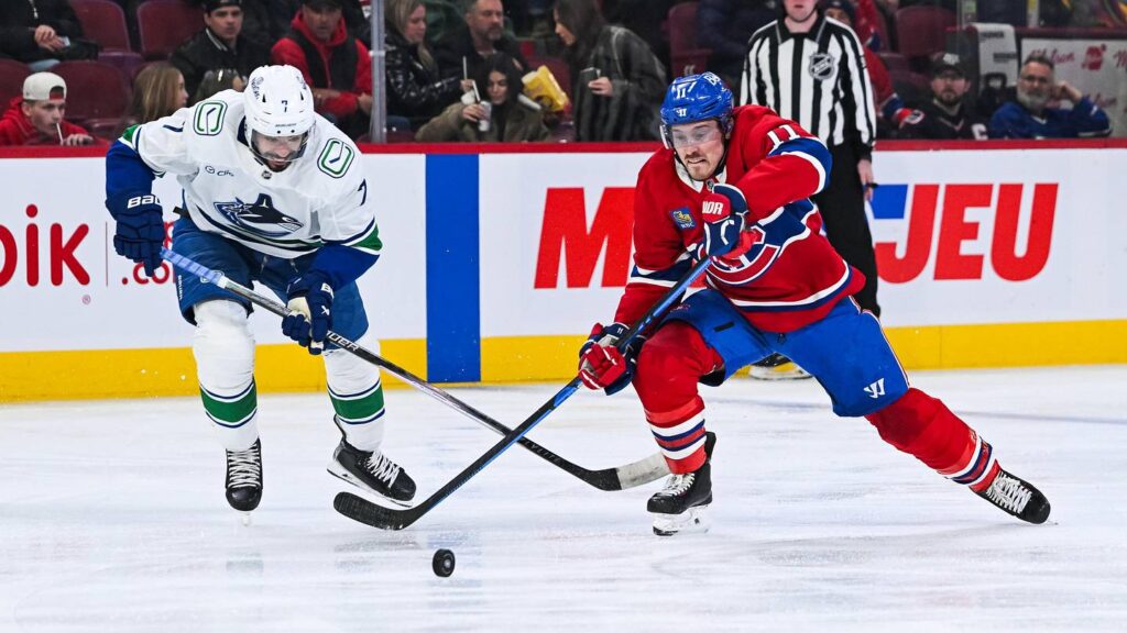 Jan 12, 2026; Montreal, Quebec, CAN; Montreal Canadiens right wing Brendan Gallagher (11) plays the puck against Vancouver Canucks defenseman Pierre-Olivier Joseph (7) during the second period at Bell Centre. Mandatory Credit: David Kirouac-Imagn Images