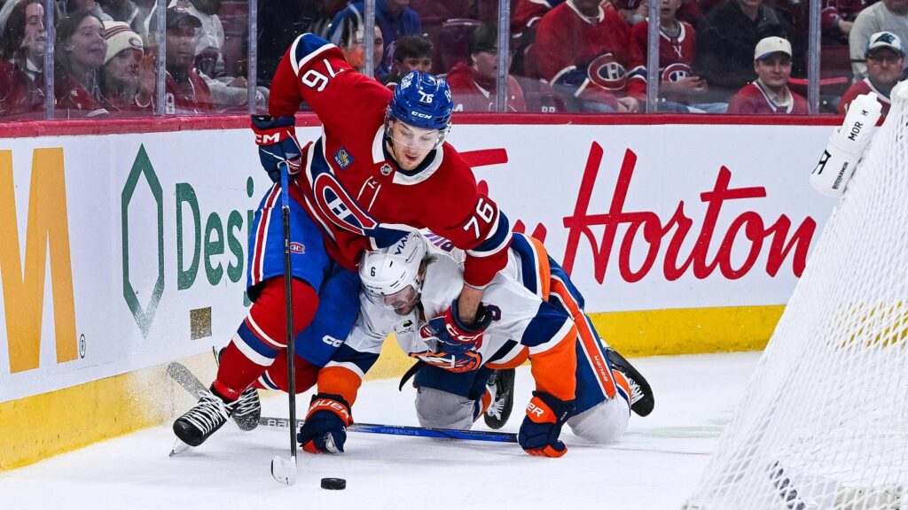 Mar 21, 2026; Montreal, Quebec, CAN; Montreal Canadiens right wing Zachary Bolduc (76) plays the puck against New York Islanders defenseman Ryan Pulock (6) during the third period at Bell Centre. Mandatory Credit: David Kirouac-Imagn Images