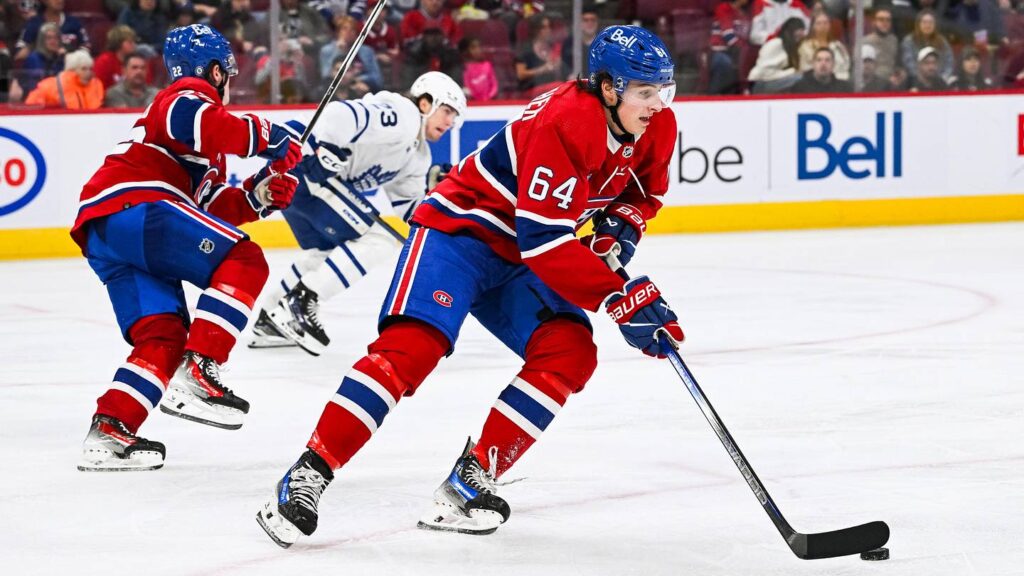 Sep 30, 2023; Montreal, Quebec, CAN; Montreal Canadiens defenseman David Reinbacher (64) plays the puck against the Toronto Maple Leafs during the third period at Bell Centre. Mandatory Credit: David Kirouac-Imagn Images