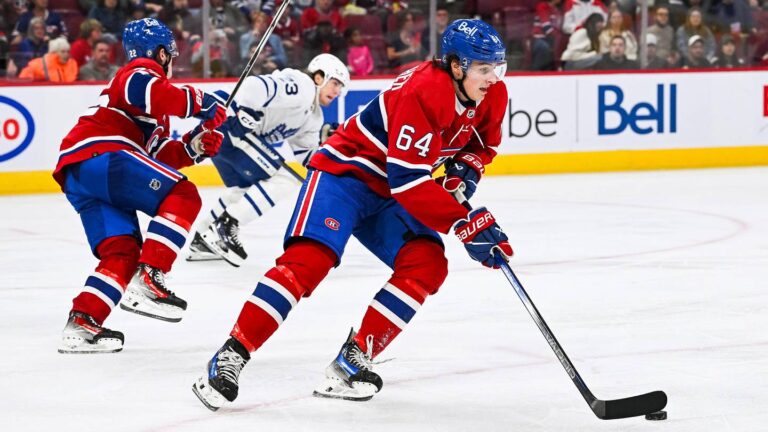 Sep 30, 2023; Montreal, Quebec, CAN; Montreal Canadiens defenseman David Reinbacher (64) plays the puck against the Toronto Maple Leafs during the third period at Bell Centre. Mandatory Credit: David Kirouac-Imagn Images