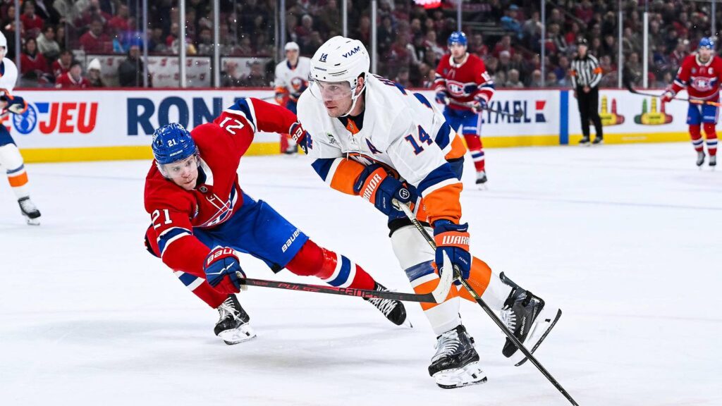 Feb 26, 2026; Montreal, Quebec, CAN; Montreal Canadiens defenseman Kaiden Guhle (21) defends against New York Islanders center Bo Horvat (14) during the third period at Bell Centre. Mandatory Credit: David Kirouac-Imagn Images