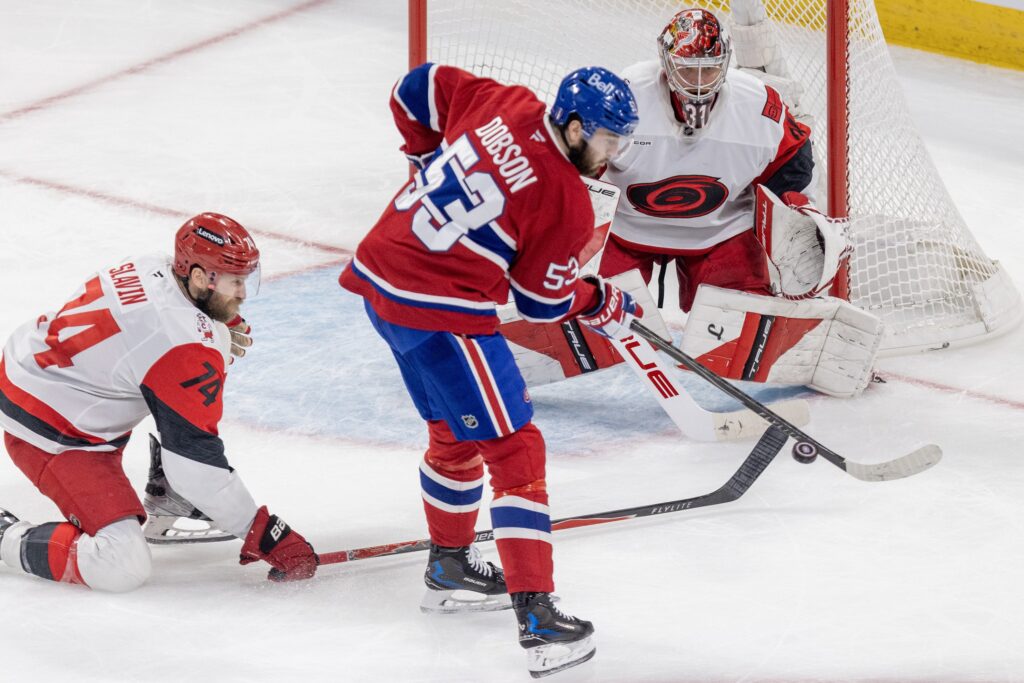 Canadiens defenceman Noah Dobson attempts to deflect a shot in front of Carolina Hurricanes goalie Frederik Andersen and Jaccob Slavin during Game 4 of Eastern Conference Final in Montreal on May 27.