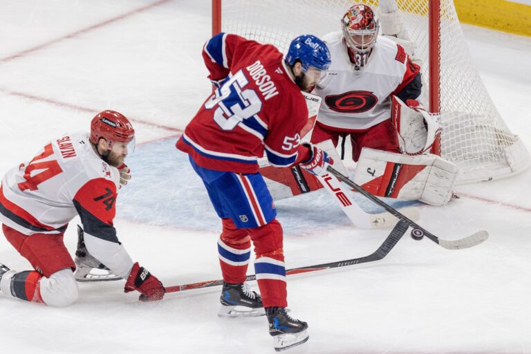Canadiens defenceman Noah Dobson attempts to deflect a shot in front of Carolina Hurricanes goalie Frederik Andersen and Jaccob Slavin during Game 4 of Eastern Conference Final in Montreal on May 27.