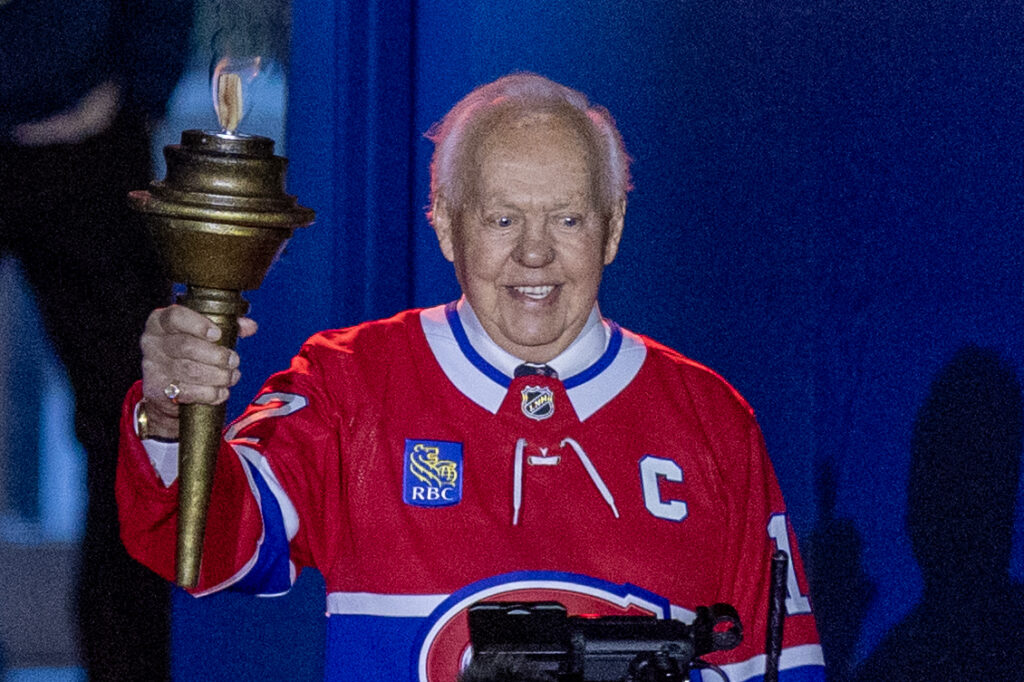 Canadiens Hall of Famer Yvan Cournoyer carries the torch into the Bell Centre before Game 3 against the Tampa Bay Lightning in Montreal on April 24.