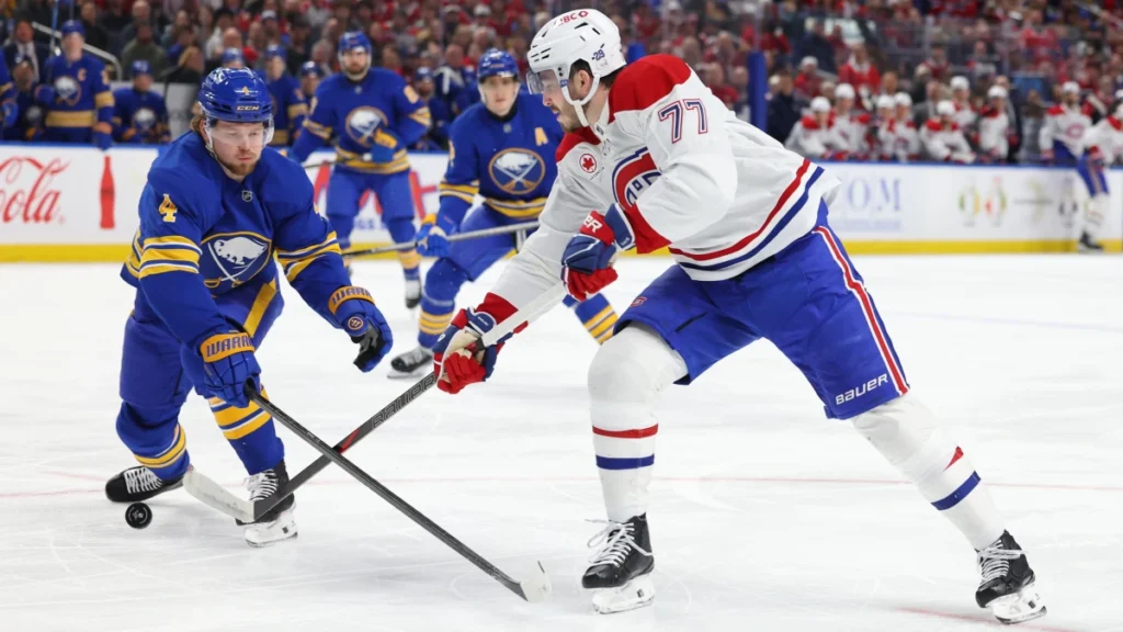 Buffalo Sabres defenseman Bowen Byram (4) tries to block a shot by Montr&eacute;al Canadiens center Kirby Dach (77) during the first period at KeyBank Center.