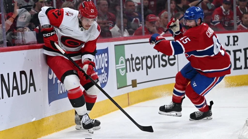 Carolina Hurricanes defenseman Alexander Nikishin (21) skates past Montreal Canadiens defenseman Alexandre Carrier (45) during the second period in game four of the Eastern Conference Final of the 2026 Stanley Cup Playoffs at Bell Centre.