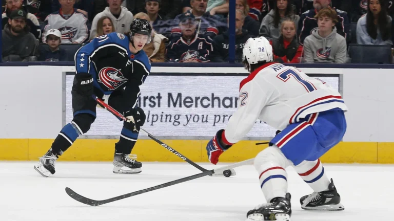 Columbus Blue Jackets left wing Kent Johnson (91) takes a shot as Montreal Canadiens defenseman Arber Xhekaj (72) during the first period at Nationwide Arena.