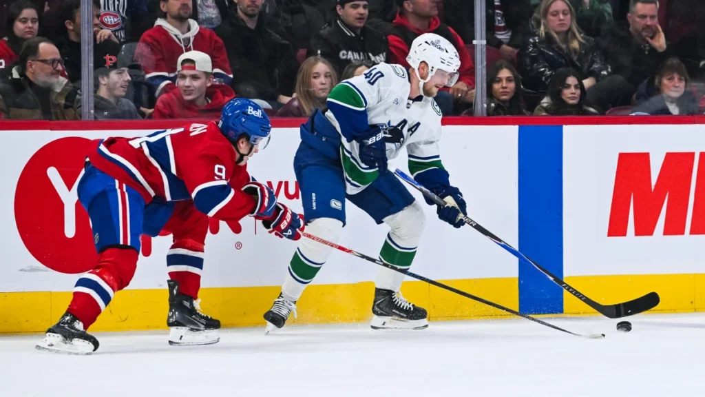 Vancouver Canucks center Elias Pettersson (40) plays the puck against Montreal Canadiens center Oliver Kapanen (91) during the third period at Bell Centre.