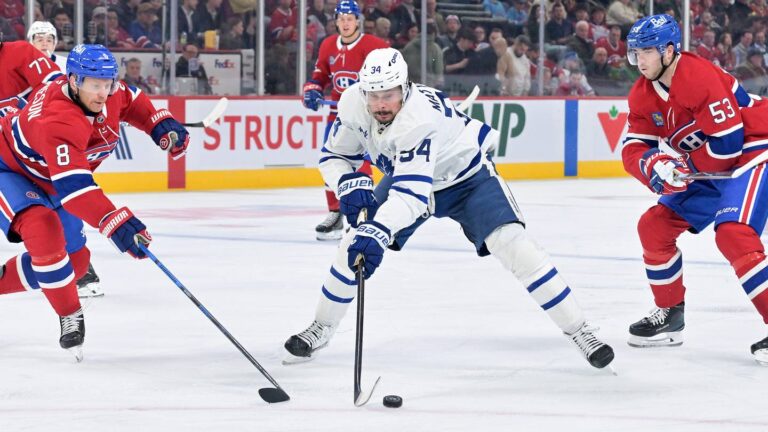 Mar 10, 2026; Montreal, Quebec, CAN; Toronto Maple Leafs forward Auston Matthews (34) plays the puck against Montreal Canadiens defensemen Mike Matheson (8) and Noah Dobson (53) during the third period at the Bell Centre. Mandatory Credit: Eric Bolte-Imagn Images